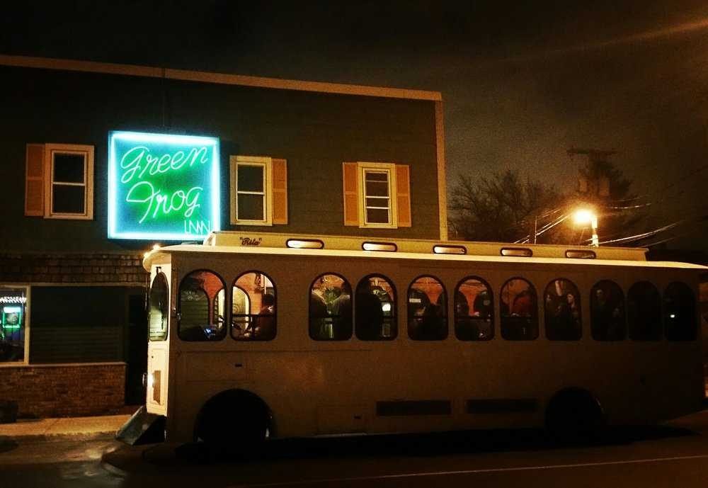 The Green Frog Inn's neon sign at night on Spring Street